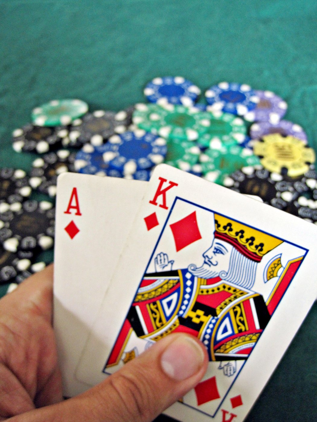 A real photo of a winning blackjack hand next to a stack of casino chips