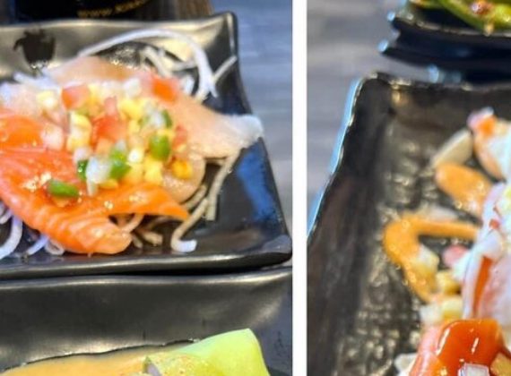 A close-up of salmon sashimi and mixed appetizers on a black plate at Sushi Neko in Las Vegas