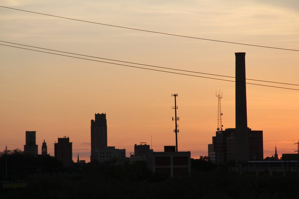 The downtown Abilene, Texas skyline silhouetted at sunset, near the Cultural District that hosts the city's Storybook Capital of America sculpture trail