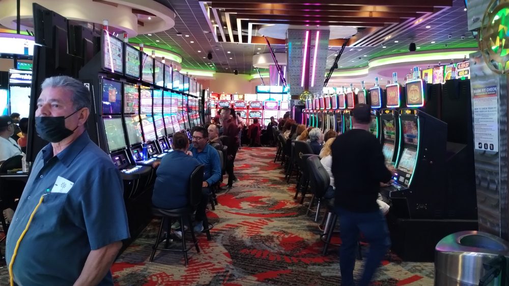 The gaming floor inside Speaking Rock Entertainment Center in El Paso, Texas, rows of lit slot machines with patrons seated and standing among them