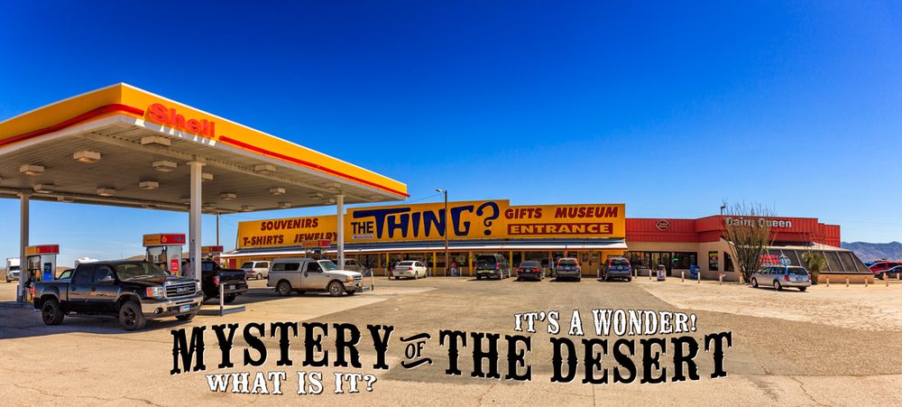 The Thing? roadside attraction storefront at a Shell gas station and Dairy Queen off I-10 in Dragoon, Arizona, with large signage reading 'Mystery of the Desert - It's a Wonder!'