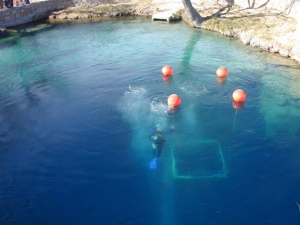 The Blue Hole, a bell-shaped, clear blue artesian well surrounded by rock in Santa Rosa, New Mexico