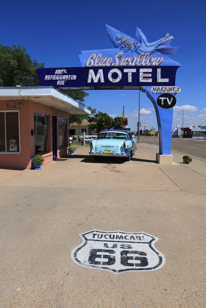 The turquoise and pink neon sign of the Blue Swallow Motel on historic Route 66 in Tucumcari, New Mexico