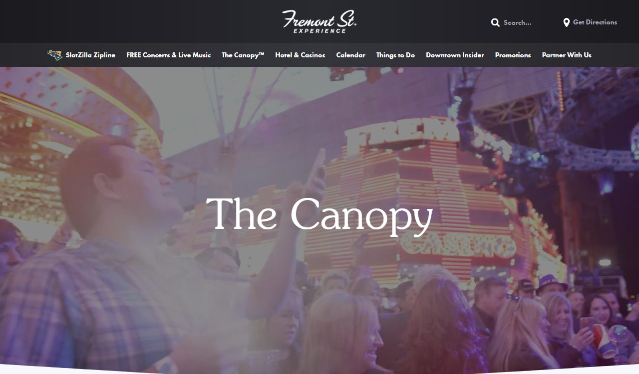 The Canopy's own webpage, describing Viva Vision as 'Vegas' Neon Sky,' over a photo of a cheering crowd beneath the illuminated Fremont Street LED canopy