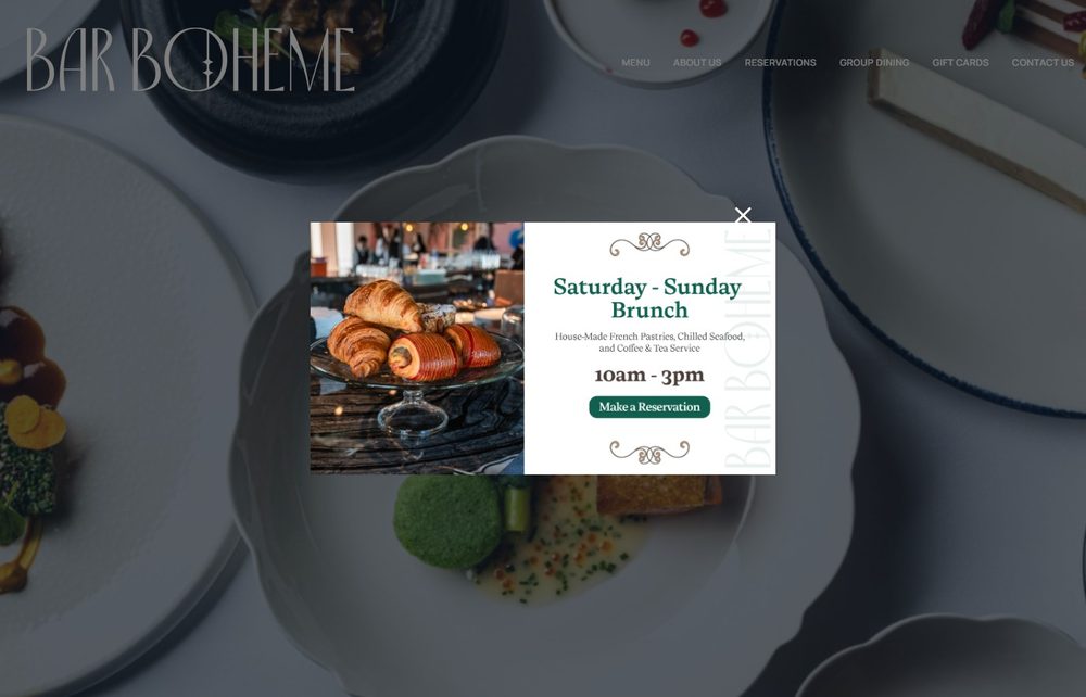 Bar Boheme's own homepage, showing its elegant French-restaurant branding over a photo of a table set with fine dining plates