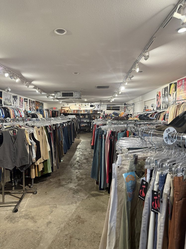 Interior of The Red Kat Vintage clothing store on Main Street, with racks of clothing and a wall of vintage music posters