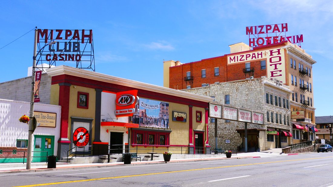 The historic Mizpah Hotel and Mizpah Club Casino in downtown Tonopah, Nevada, with vintage red neon signage reading Mizpah Hotel on the rooftop