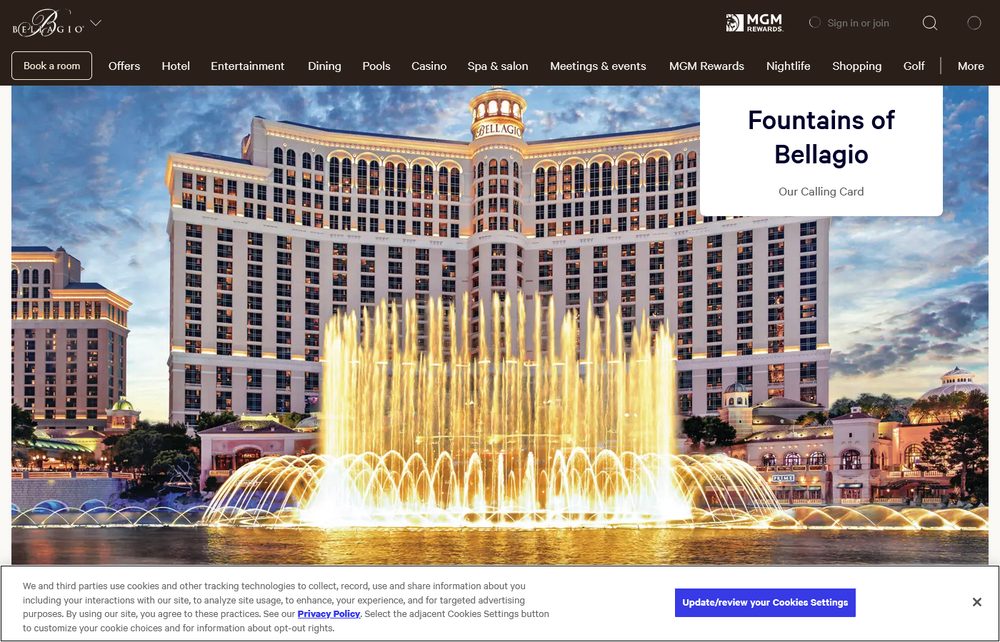 The Fountains of Bellagio erupting in front of the Bellagio hotel at dusk, with golden-lit water jets soaring in front of the building
