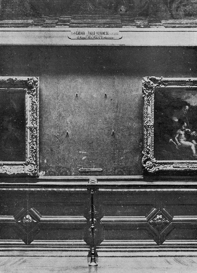 The empty wall in the Louvre's Salon Carre where the Mona Lisa hung, photographed shortly after the 1911 theft, showing the four iron pegs left behind