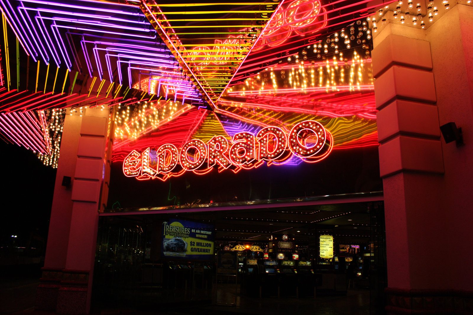 The illuminated purple, red, and yellow neon starburst canopy and marquee reading 'Eldorado' over the entrance to the Eldorado Resort Casino in downtown Reno at night