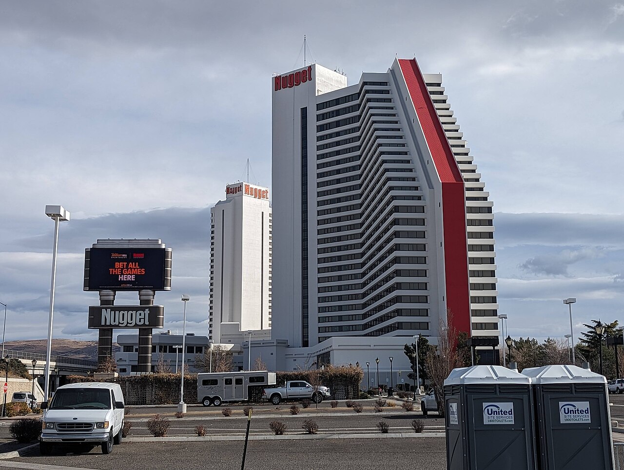 The Nugget Casino Resort's two connected hotel towers in downtown Sparks, Nevada, with a large freestanding Nugget sign and digital marquee in the foreground