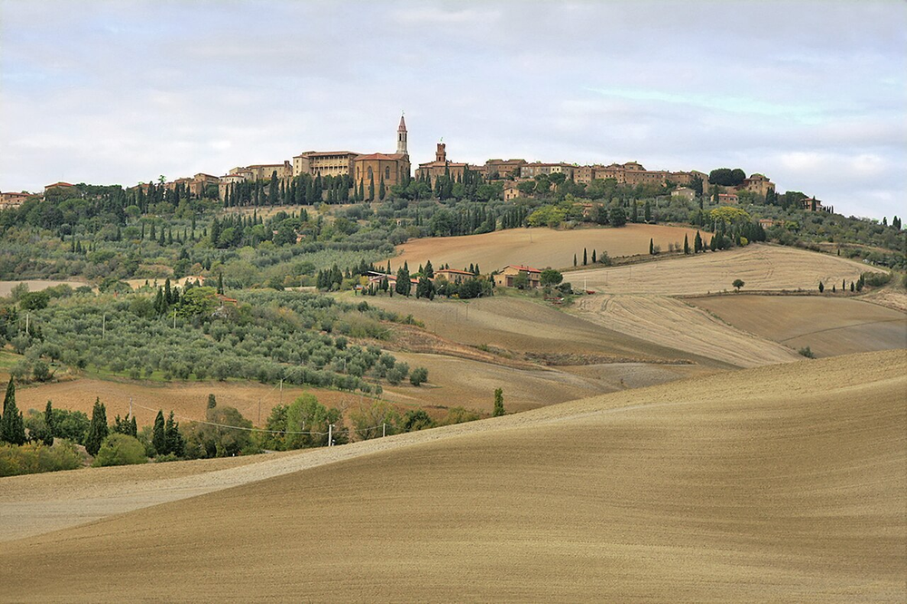 Wikipedia's Pienza article showing a photo of the Renaissance central piazza and the town's hilltop silhouette above the Tuscan countryside