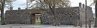 The exterior wall of Cove Fort, Utah, built from black volcanic rock and dark limestone in 1867