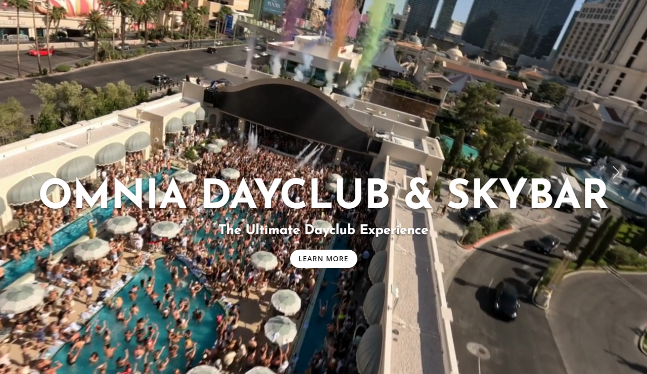 Caesars Palace's official site showing an aerial view of the Omnia Dayclub and Skybar pool deck packed with guests and umbrellas, directly overlooking the Las Vegas Strip